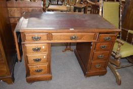 Late Victorian American walnut twin pedestal desk with nine drawers and a drop leaf extension to one