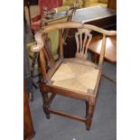 Large Georgian elm framed bow back corner chair with pierced splat over a push out rush seat and