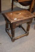 Antique oak joint stool of typical form raised on turned legs with ribbed decoration to sides,