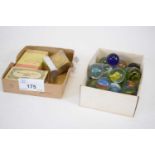 Small box containing quantity of marbles and further box with quantity of match strikers and small