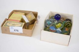 Small box containing quantity of marbles and further box with quantity of match strikers and small