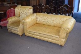 Early 20th century drop end two-seater sofa and accompanying wing back armchair, both requiring re-