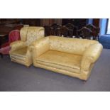 Early 20th century drop end two-seater sofa and accompanying wing back armchair, both requiring re-