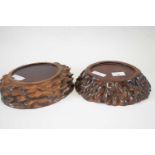 Pair of wooden stands, modelled as elephant footprints, the oval tops 17cm long (2)