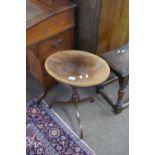 20th century mahogany veneered oval top wine table raised on a turned column with tripod base,