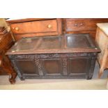 18th century oak coffer, the three panelled lid over a body with three panelled front surrounded