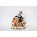 Large Italian pottery model of a man on bench on shaped base