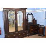 Late Victorian dark stained walnut bedroom suite comprising wardrobe with moulded cornice over two