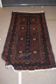 20th century Middle Eastern Belouch carpet decorated with eight central lozenges on a dark blue