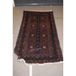 20th century Middle Eastern Belouch carpet decorated with eight central lozenges on a dark blue