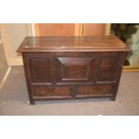 18th century oak mule chest with a hinged lid over a body with three panelled front over two drawers