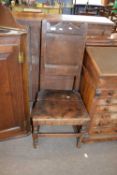 17th century oak side chair with shaped top rail over a single panelled back and a boarded seat