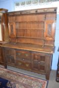 Late 19th century oak dresser, the top section with shelves and two small cupboards over a base with