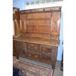 Late 19th century oak dresser, the top section with shelves and two small cupboards over a base with