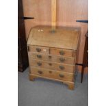 18th century oak bureau with fall front opening to an interior with pigeonholes and small