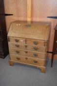 18th century oak bureau with fall front opening to an interior with pigeonholes and small