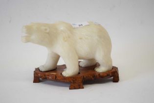 Alabaster model of a polar bear on wooden stand, 20cm long