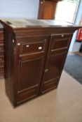 Georgian oak two-door cupboard with moulded cornice over two panelled doors opening to a shelved