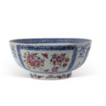 18th century Chinese export punch bowl decorated with flowers in famille rose enamels within blue
