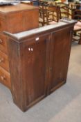 Georgian oak two-door cupboard with moulded cornice over two panelled doors opening to a shelved