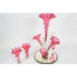 Late 19th century cranberry coloured glass epergne with a central and two flower holders and two