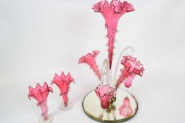 Late 19th century cranberry coloured glass epergne with a central and two flower holders and two