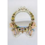 Continental porcelain mirror, probably Sitzendorf, with two cherubs with floral decoration, 30cm