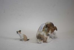 A Lladro model of a terrier with butterfly seated on its tail together with a smaller example (2)