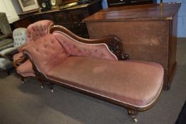 Victorian mahogany framed chaise longue with scrolled back and buttoned upholstery, raised on