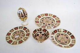 Group of Royal Crown Derby wares, two small plates, a saucer and Royal Crown Derby egg and stand