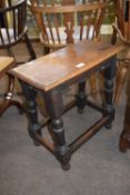 Antique oak joint stool raised on turned legs, 51cm wide