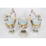 Group of three Continental porcelain ewers decorated in Capo di Monte style comprising pair of ewers