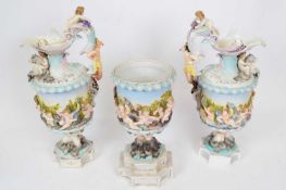 Group of three Continental porcelain ewers decorated in Capo di Monte style comprising pair of ewers