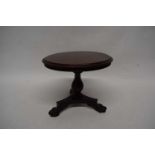 19th century apprentice mahogany dining table, the circular top raised on a turned column and