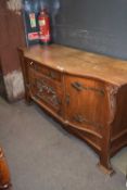 Late 19th century oak sideboard in the Arts & Crafts style, the bowed front with three doors and a