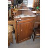 George III oak corner cabinet with graduated shelves over a single panelled door opening to an