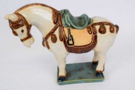 Oriental model of a horse with Han or Tang style glazes, standing on rectangular base, 25cm high