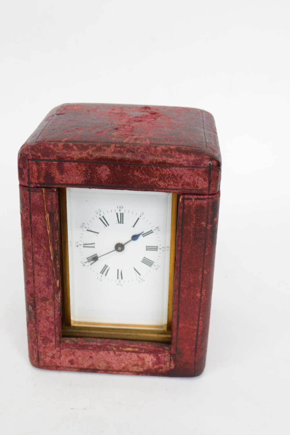 Late 19th century French brass carriage clock with white enamel dial and Roman numerals, in original