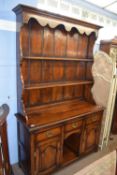 Good quality reproduction oak dresser by Eric Bates & Sons, the back section with a moulded cornice,