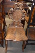 Late 19th century Black Forest hall chair with elaborately carved and pierced back over a seat