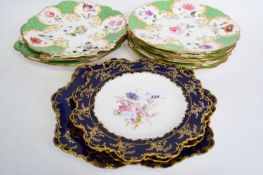 Group of Royal Crown Derby plates with floral designs within blue and gilt borders comprising two