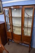 Edwardian mahogany and inlaid china cabinet with two glazed doors and bowed centre section raised on