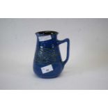 Barnstaple Pottery blue glazed jug with Art Deco motif decoration in green, 17cm high