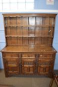 Good quality reproduction oak dresser with moulded cornice and two shelves to back over a base