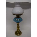 Brass oil lamp with blue ground ceramic reservoir decorated with flowers68cm long