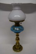 Brass oil lamp with blue ground ceramic reservoir decorated with flowers68cm long