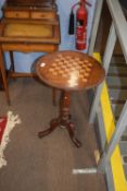Small Victorian walnut veneered and inlaid games table with circular top, raised on turned column