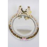 Sitzendorf porcelain oval mirror with white ceramic frame, surmounted by two cherubs, 30cm long