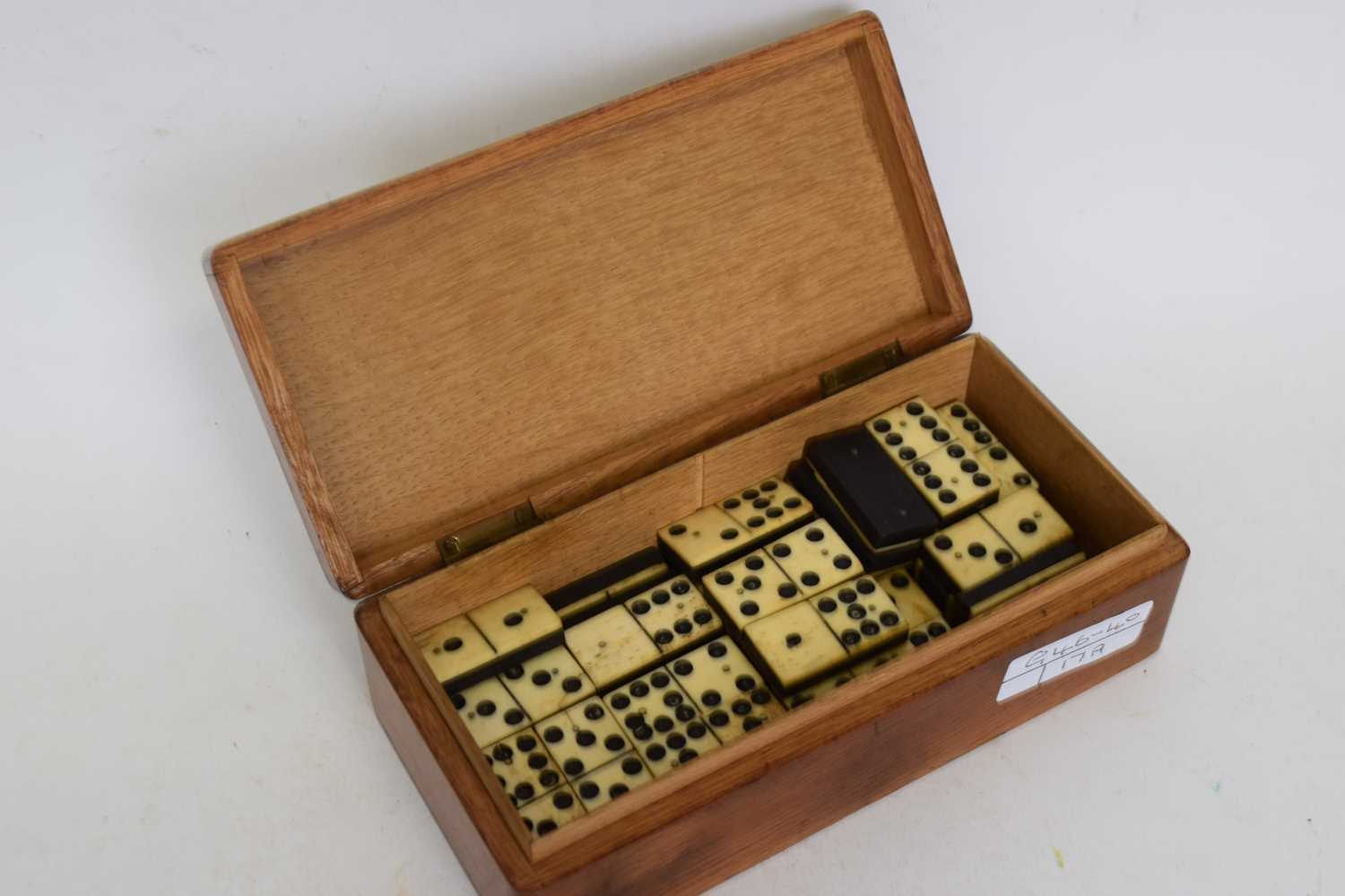 Box containing quantity of dominoes