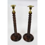 Pair of barley twist oak candlesticks with brass sconces, 50cm high (2)